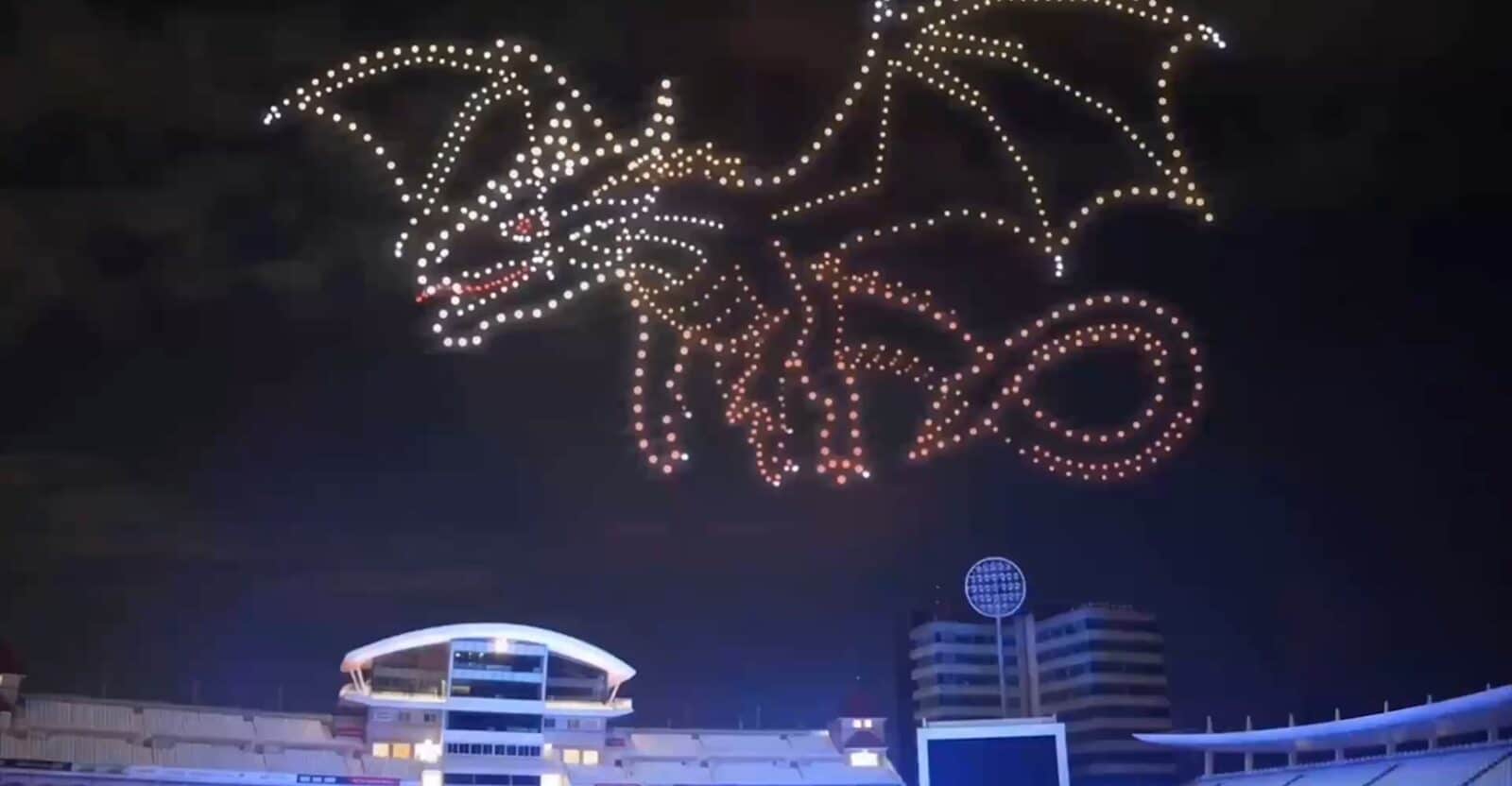 A large, bright green dragon drone display with yellow accents against a dark night sky at the Sky Kingdom: A Dragon Drone Light Show.