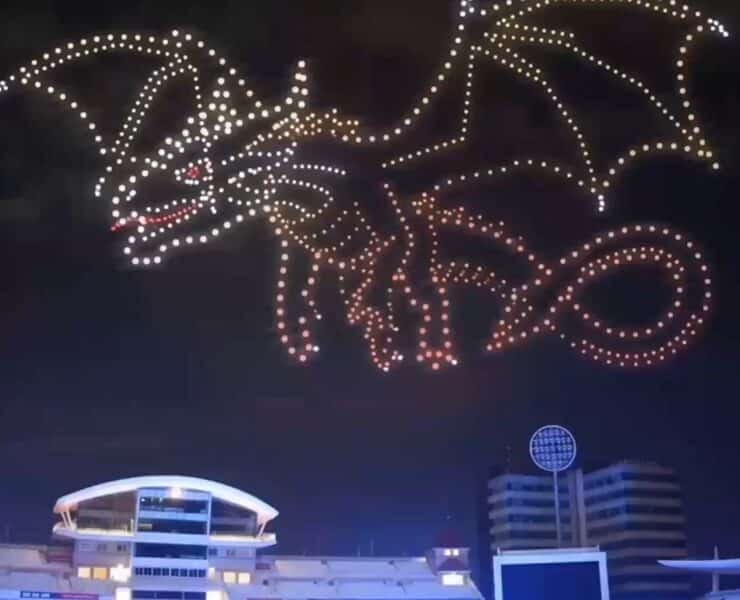 A large, bright green dragon drone display with yellow accents against a dark night sky at the Sky Kingdom: A Dragon Drone Light Show.