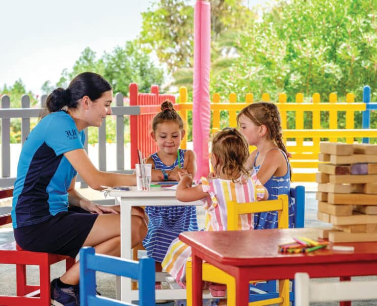 tui representitive with three young children round a white table