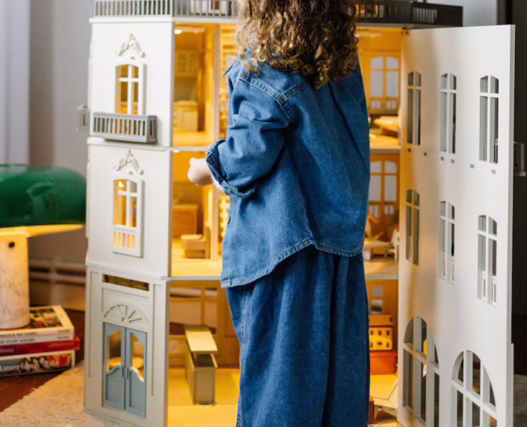 A detailed close-up of the interior of a luxury dollhouse, showing miniature furniture and intricate decorations.