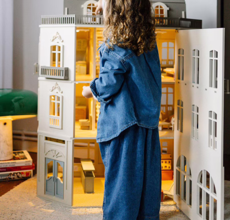 A detailed close-up of the interior of a luxury dollhouse, showing miniature furniture and intricate decorations.