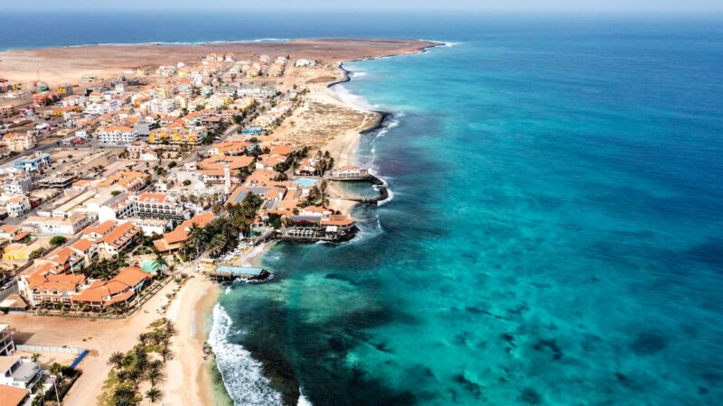 An aerial view captures the turquoise waters and sandy coastline of Santa Maria on Sal Island, Cape Verde